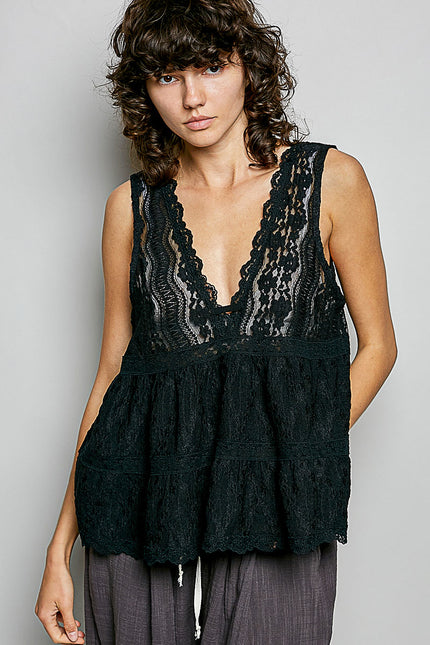 Black lace sleeveless top with deep V-neck, scalloped edges, and tiered ruffled hem on model