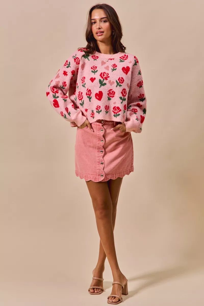 Pink vintage wash denim mini skirt with scalloped edge and button front.