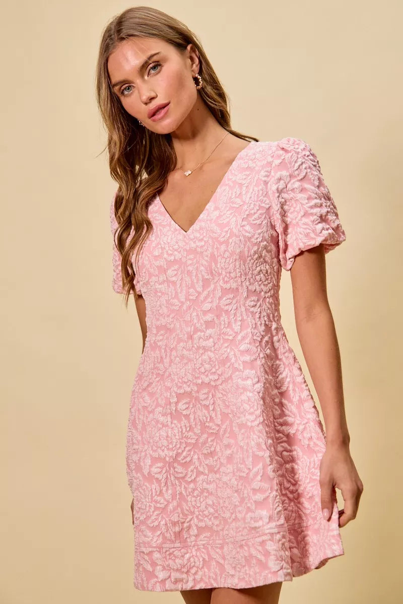 Floral jacquard mini dress shown from back highlighting flared hem