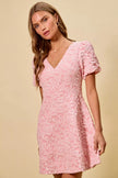 Floral jacquard mini dress shown from back highlighting flared hem