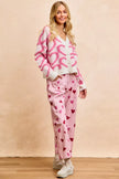 Pink textured heart patterned buttoned V neck cardigan with cozy knit fabric and relaxed fit.
