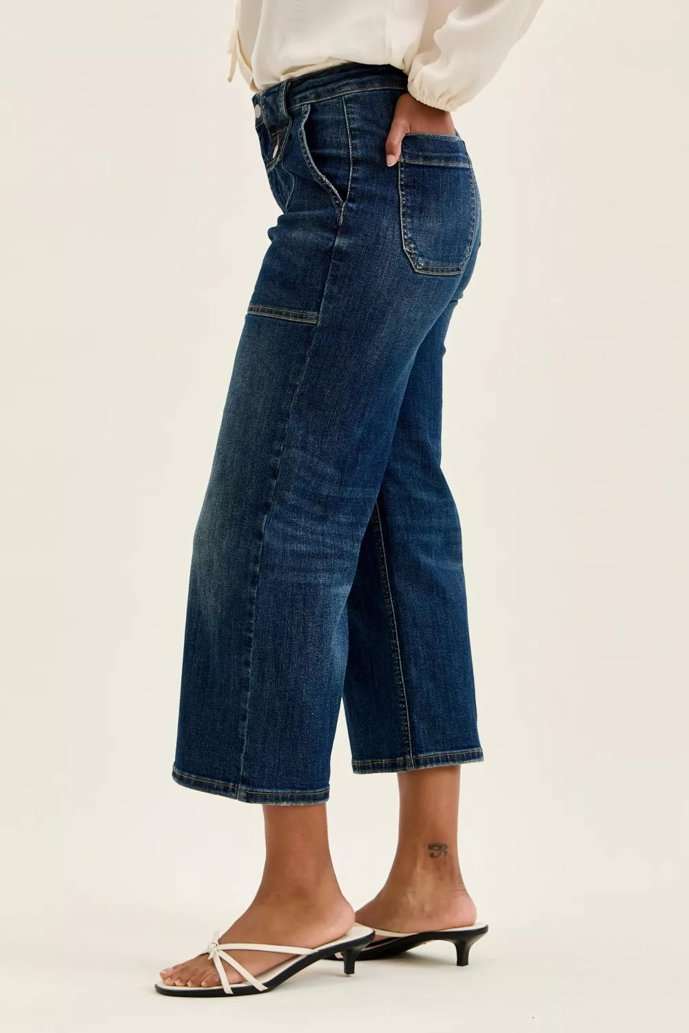 Dark indigo high-waisted wide-leg utility jeans with patch pockets, durable cotton blend, elongating fit, cropped length