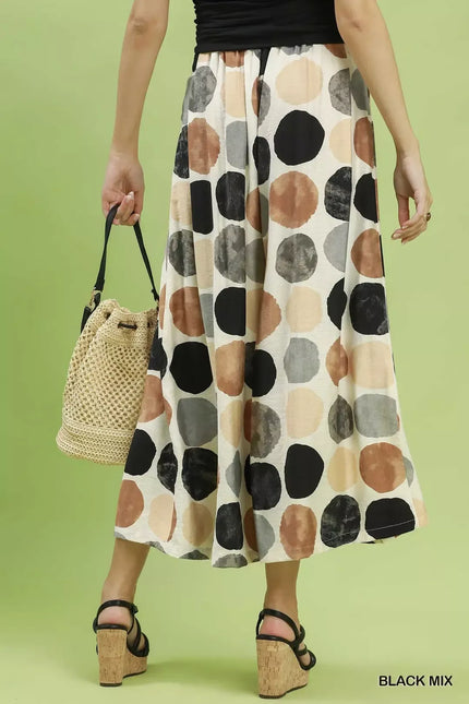 Women's beige wide leg flowy trousers with multi colored dot print and elastic waist