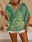 Green and yellow patterned V-neck top with button front and loose fit.