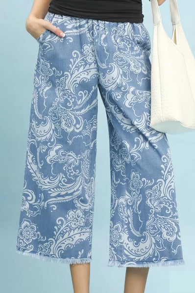 Blue stone wash denim wide leg crop pants with white floral print frayed hem