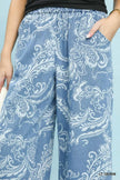 Light blue stone wash denim wide leg crop pants with white floral patterns