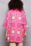Stylish crochet top showcasing floral granny square pattern and button details
