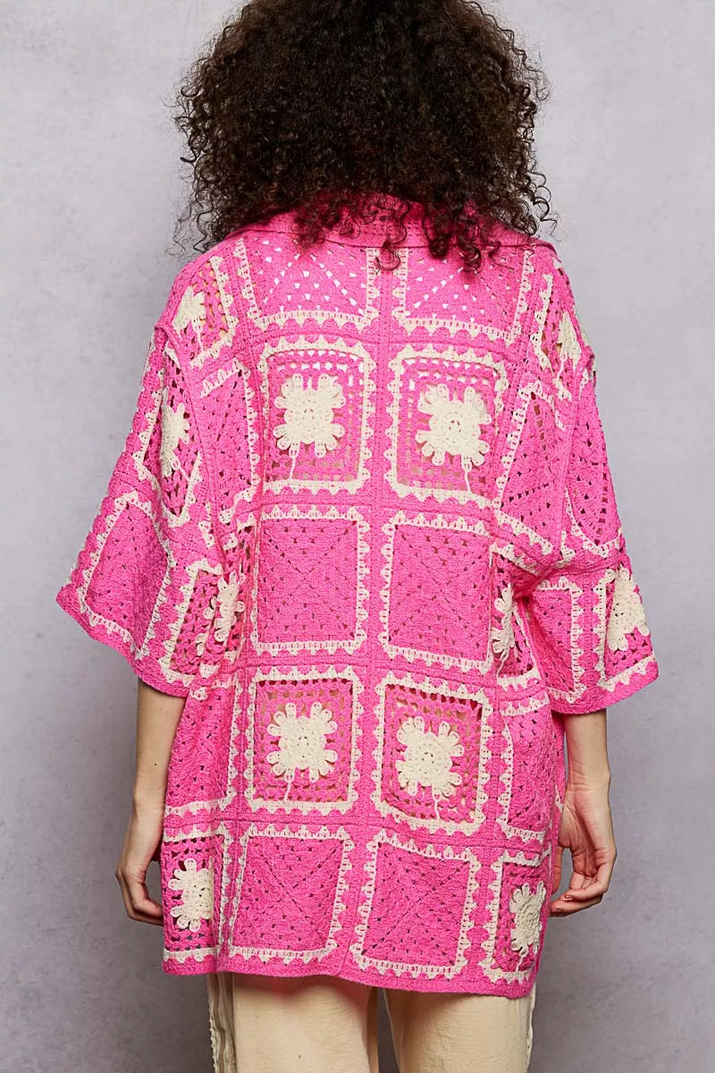 Stylish crochet top showcasing floral granny square pattern and button details