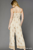 Side profile of cream latte print jumpsuit with relaxed fit