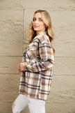 Buttoned plaid shirt jacket featuring classic check pattern and flat collar