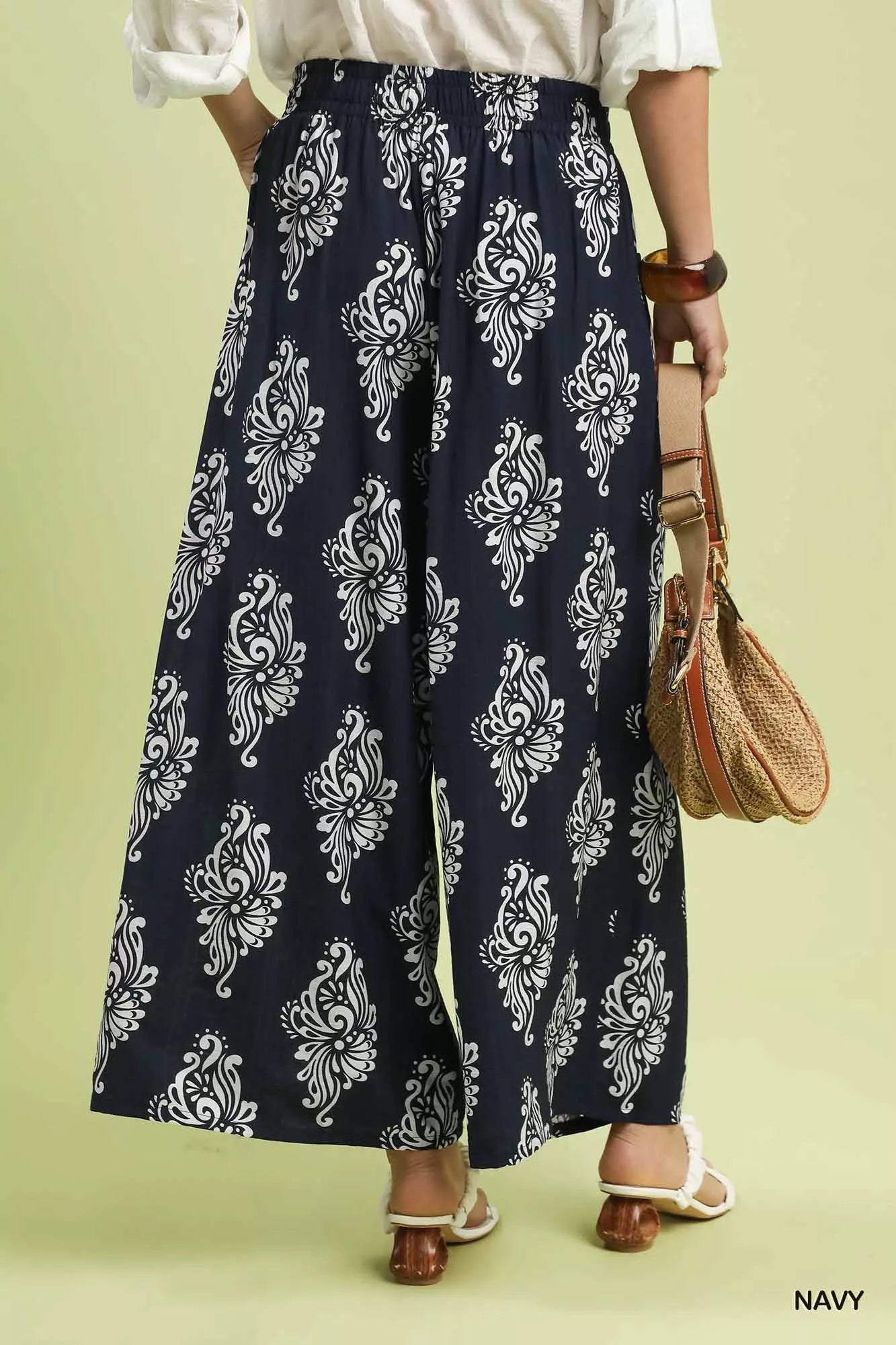 Navy wide-leg pants showing contrast trim at hem