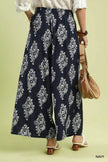 Navy wide-leg pants showing contrast trim at hem