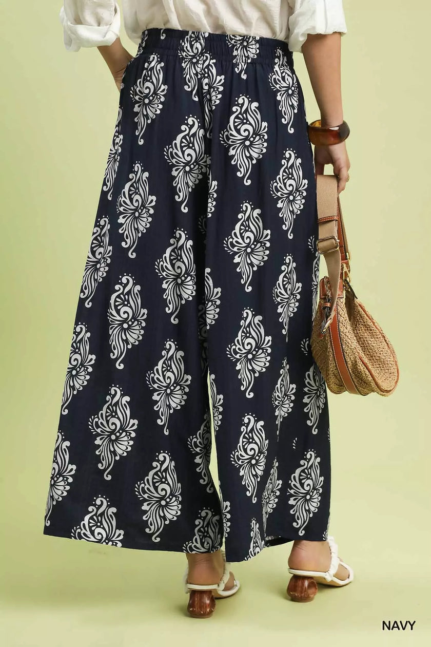 Navy wide-leg pants showing contrast trim at hem