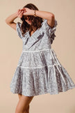 Gray and white cotton dress with ruffled neckline and side tie details