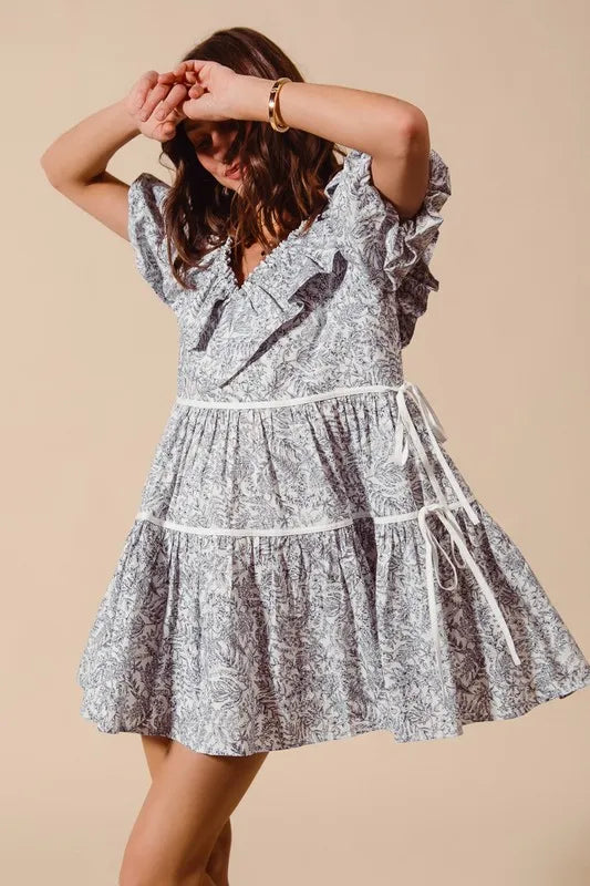 Gray and white cotton dress with ruffled neckline and side tie details