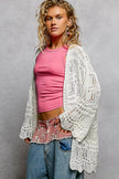 White openwork cardigan with scalloped edge, lightweight knit, loose fit over pink top.