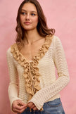 Cream and beige pointelle knit cardigan with ruffled lace front and tie detail