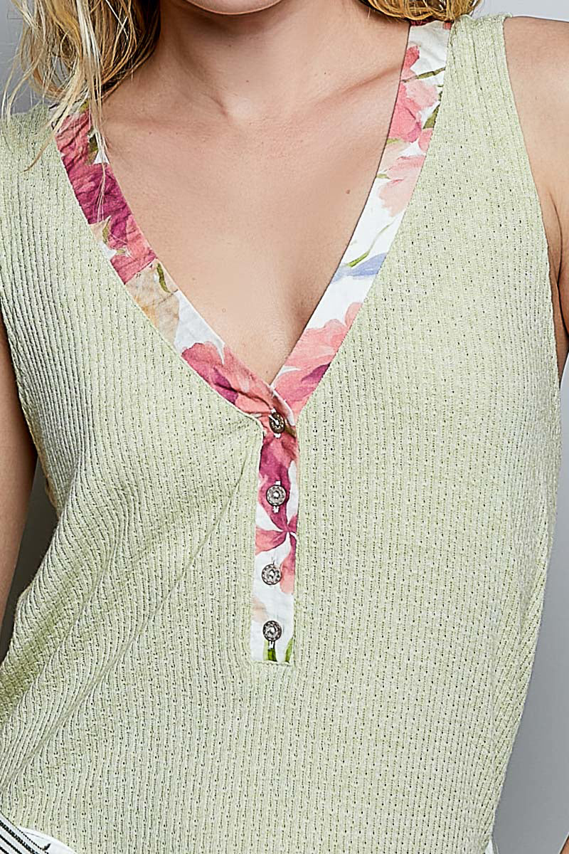 Light green ribbed V-neck tank top with floral contrast trim and button placket
