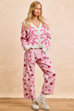 Pink textured heart cardigan with pearl buttons, cozy knit, loose fit, V-neck style