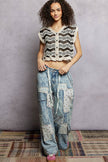 Cream and black crochet button-down boho vest with scalloped edges and open knit texture