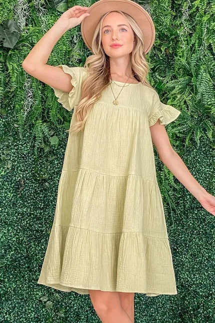 Lime green cotton gauze dress with ruffled sleeves and tiered skirt, relaxed fit