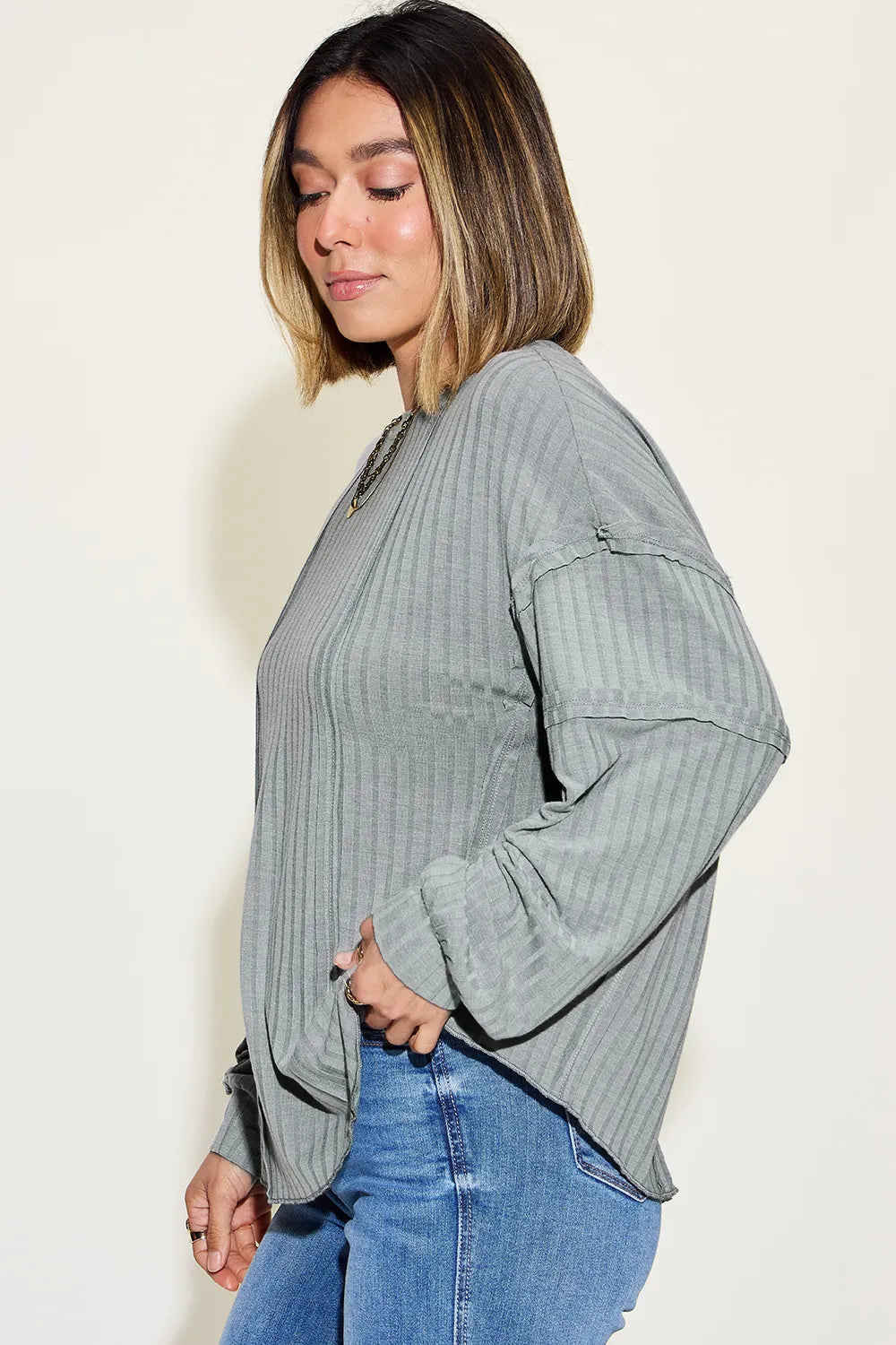 Model wearing ribbed long sleeve tshirt with tapered waist