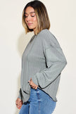 Model wearing ribbed long sleeve tshirt with tapered waist
