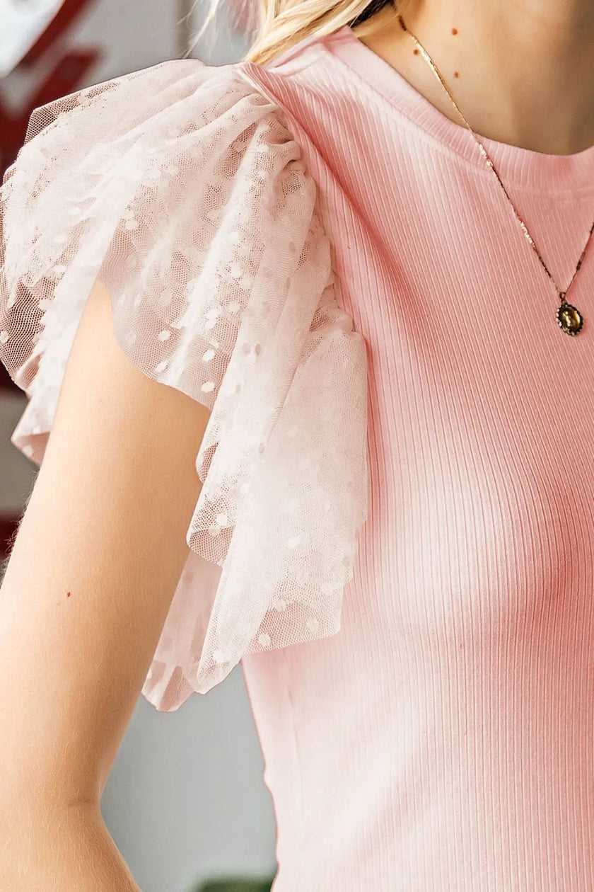 Pink ribbed blouse with white lace ruffled cap sleeves and round neck.