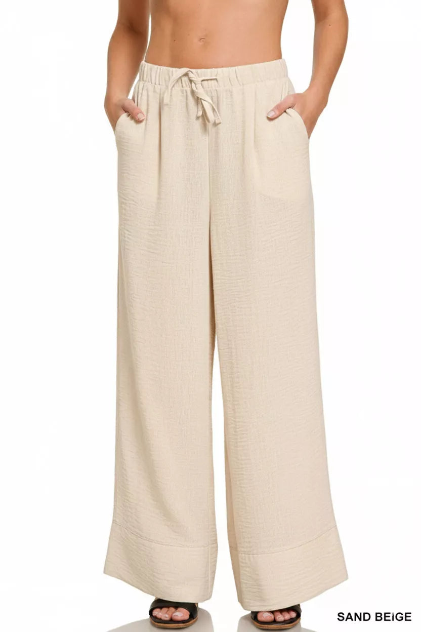 Lightweight drawstring pants shown on model from side
