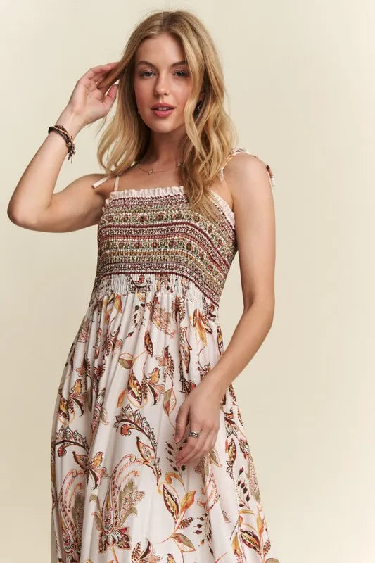 Flowy sheer midi dress featuring smocked details and adjustable tie shoulders