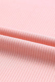 Soft pink ribbed knit ruffled round neck cap sleeve blouse close-up texture