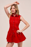 Woman wearing crimson red sleeveless dress with ruffled collar