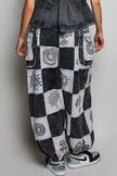 High-rise patchwork joggers with grey and black Aztec prints, drawstring waist, and cargo pockets