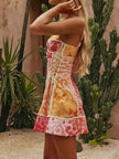 Vibrant floral print lace-up mini dress with corset fit and patchwork texture.