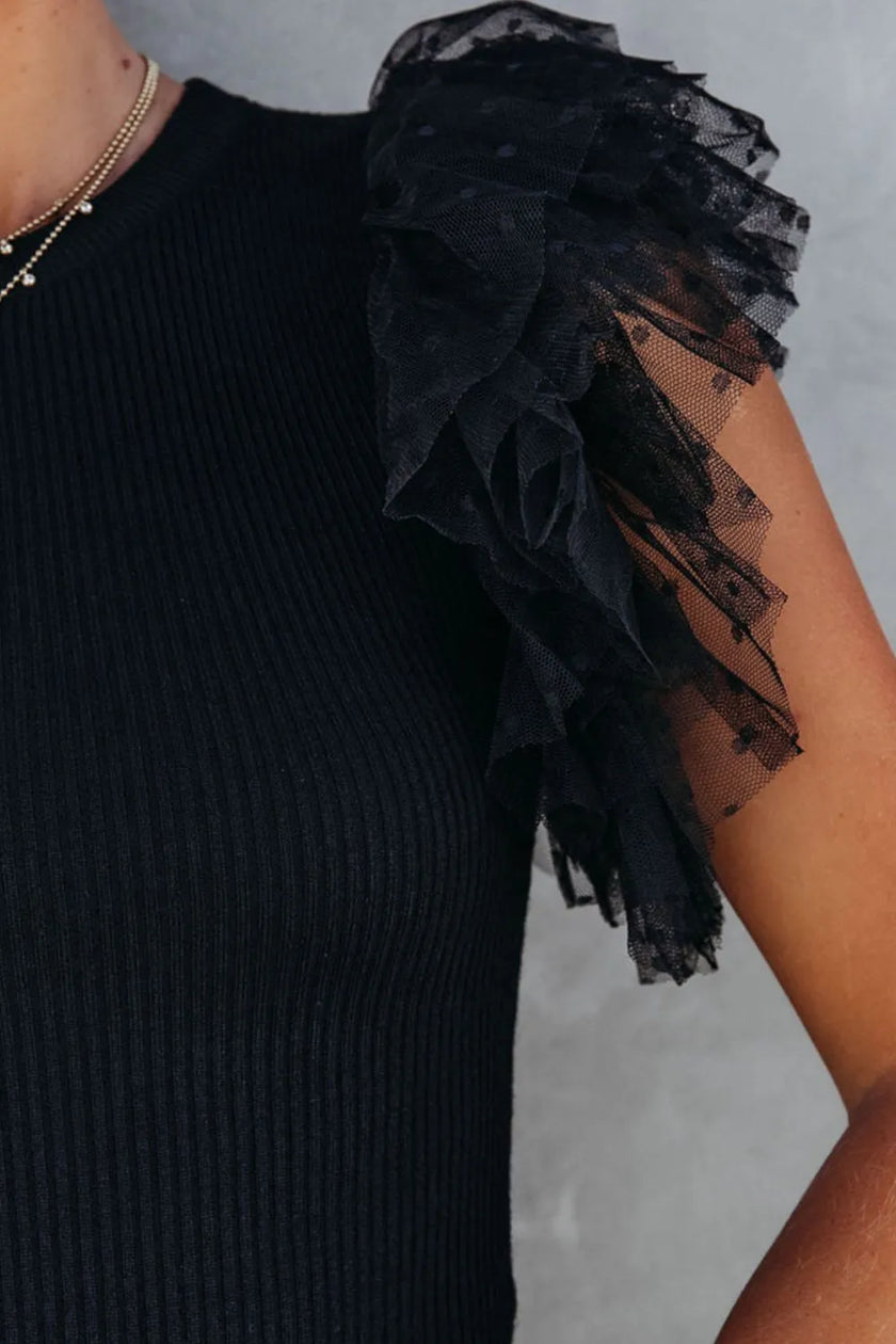 Black ribbed knit blouse with layered ruffled cap sleeve detail.