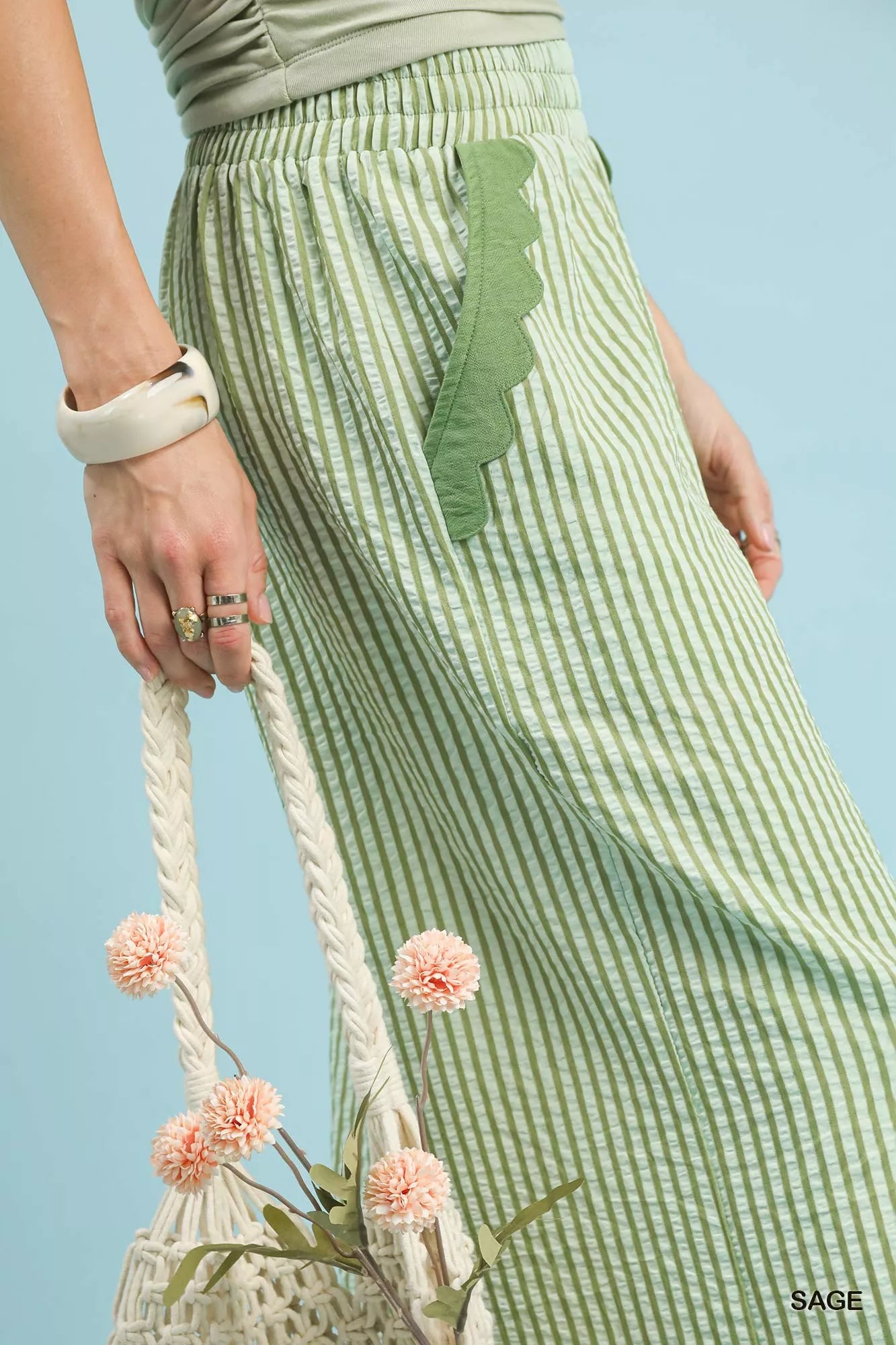 Feminine scallop hem design on wide-leg trousers