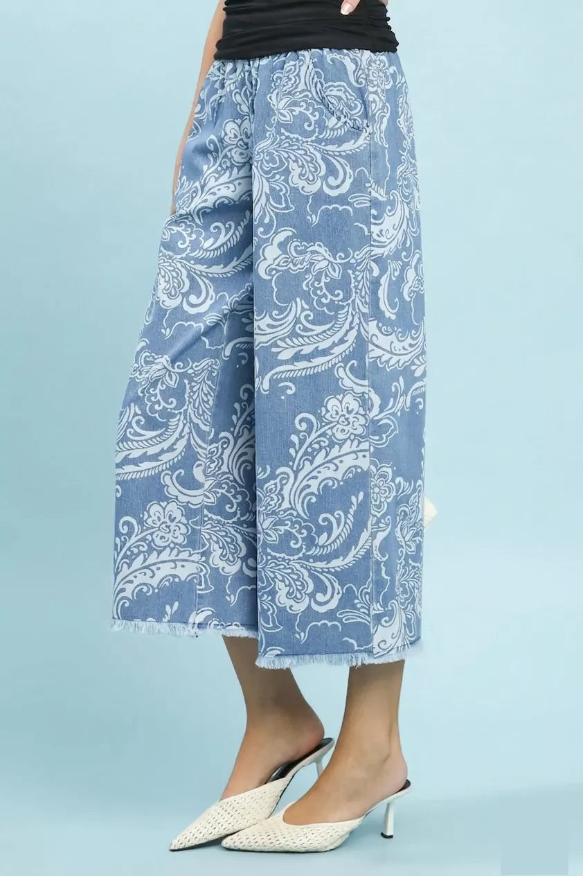 Blue stone wash denim wide leg crop pants with white floral print frayed hem