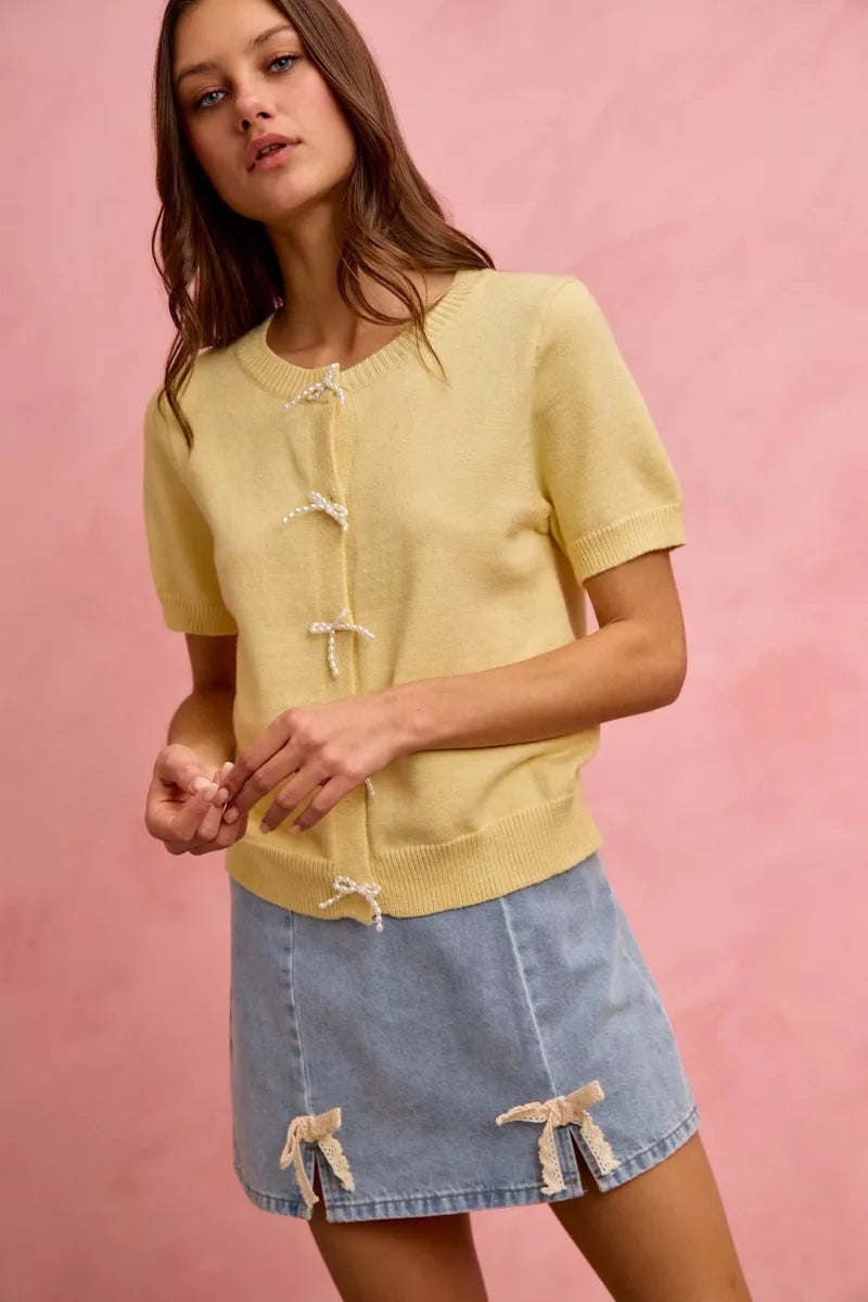 Light blue denim mini skirt with lace ribbon bow trim and slit hem