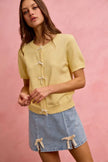 Light blue denim mini skirt with lace ribbon bow trim and slit hem