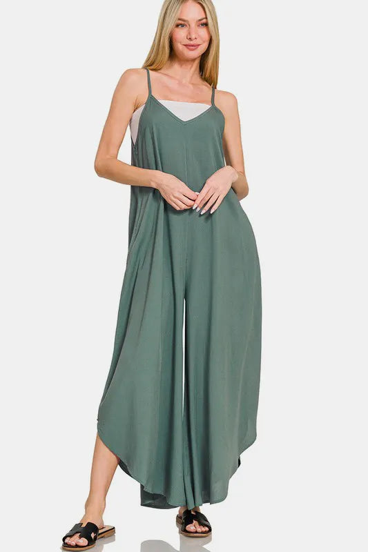Front view of sleeveless overalls featuring opaque rayon fabric and curved hem