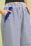 Feminine scalloped hem detail on ocean blue pants