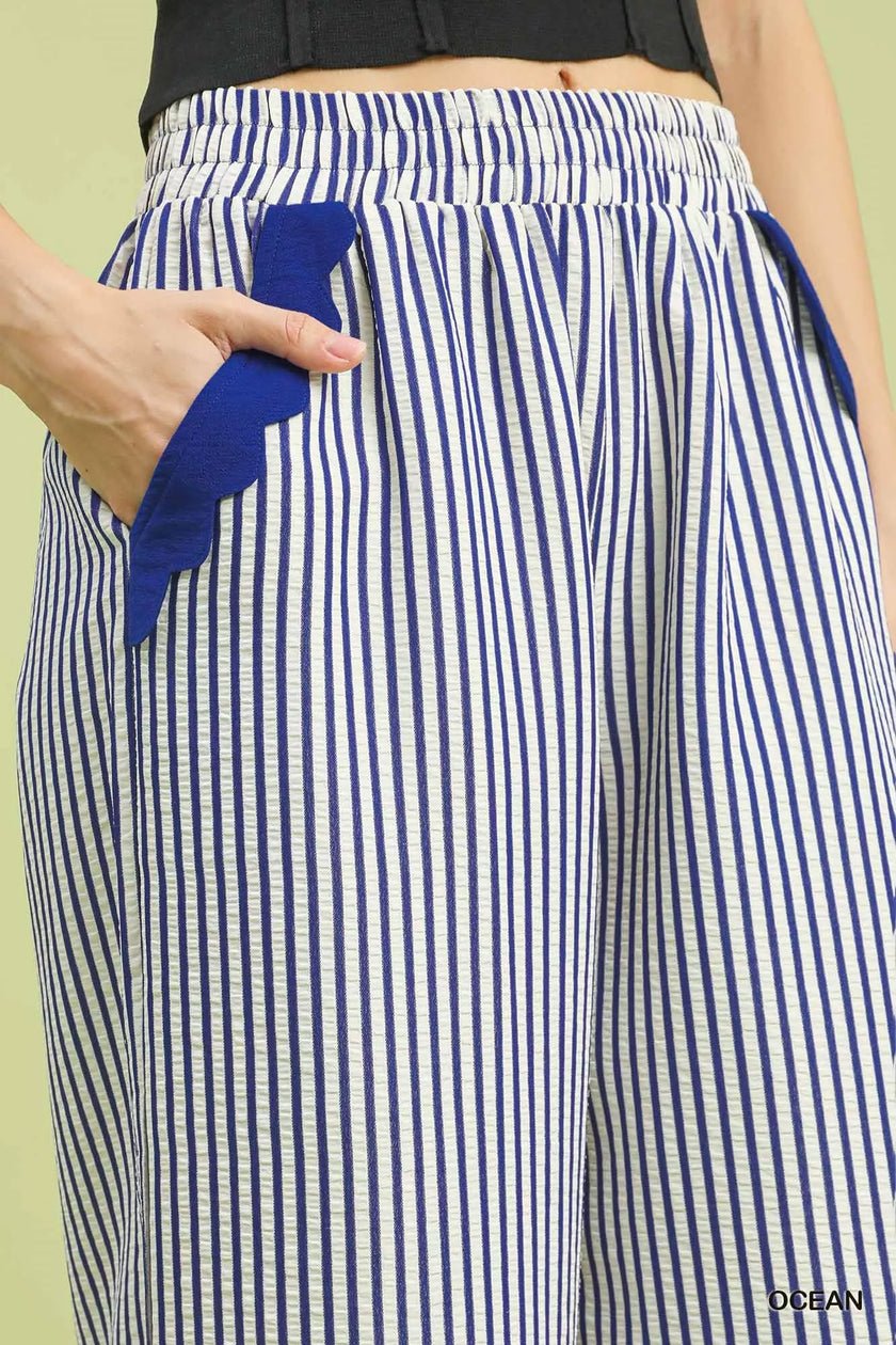 Feminine scalloped hem detail on ocean blue pants