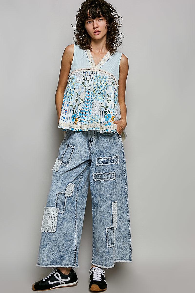 Light blue sheer V-neck tank top with floral embroidery and white lace trim