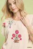 Textured embroidered floral design on linen-blend top
