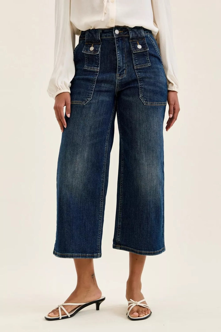 High-waisted dark blue durable cotton blend utility jeans with patch pockets, elongating fit, flared crop style