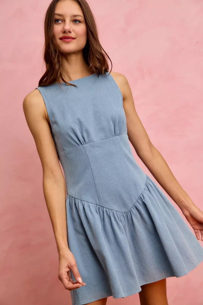 Light blue denim mini dress with fitted bodice and flared skirt.