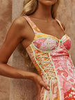 Pink orange floral print lace-up mini dress with textured fabric and fitted bodice.