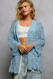 Light blue openwork cardigan with scalloped hem, loose fit, crochet texture, white top, denim pants