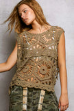 Close-up of intricate lace crochet floral pattern on tank top