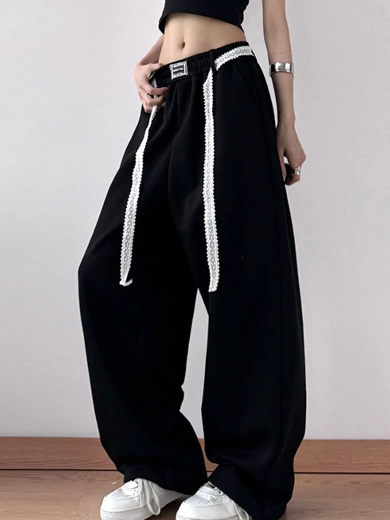 Close-up of drawstring adjustment on relaxed trousers